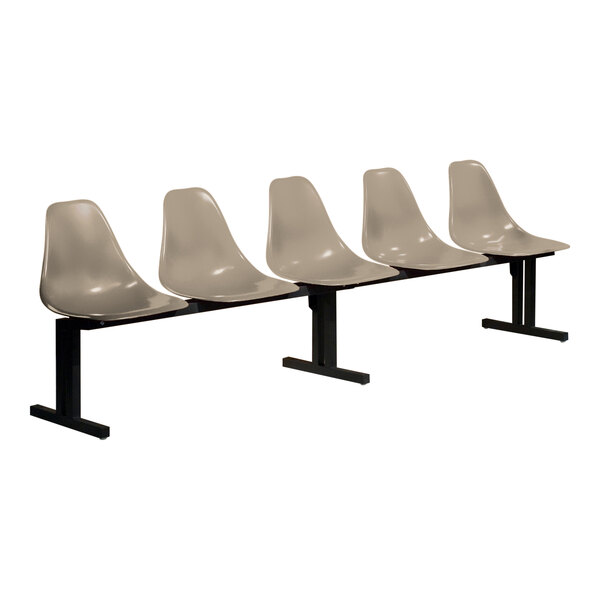A row of four white Sol-O-Matic plastic chairs with black legs.