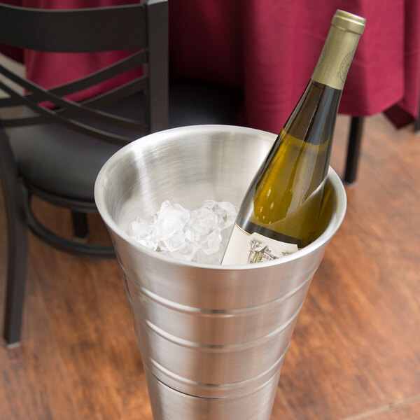 An American Metalcraft double wall swirl wine bucket holding a bottle of wine on a table.