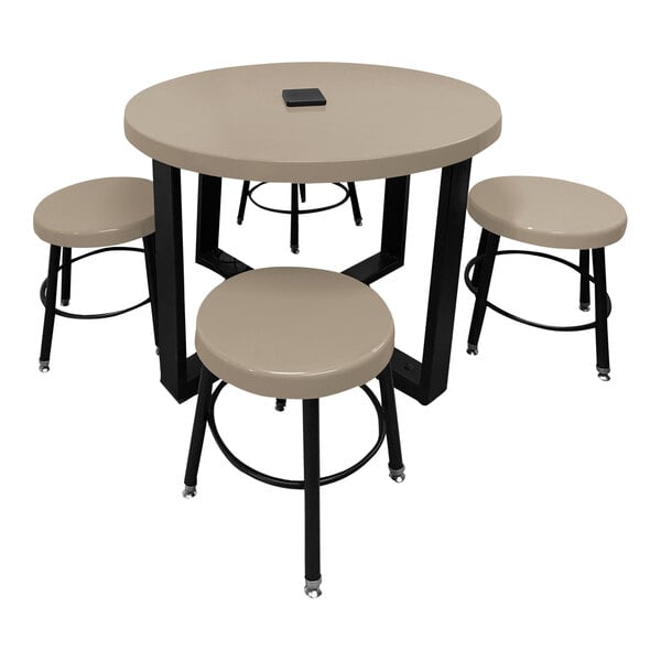 A white circular Sol-O-Matic table with black stools around it.