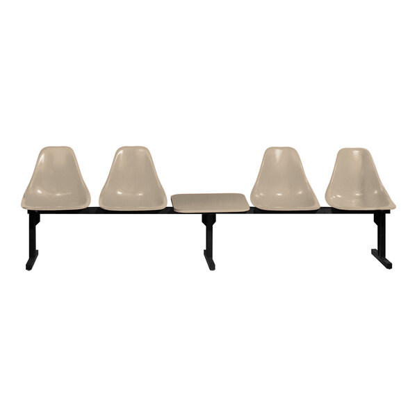 A row of three Sol-O-Matic beige plastic chairs with black bases and a table.