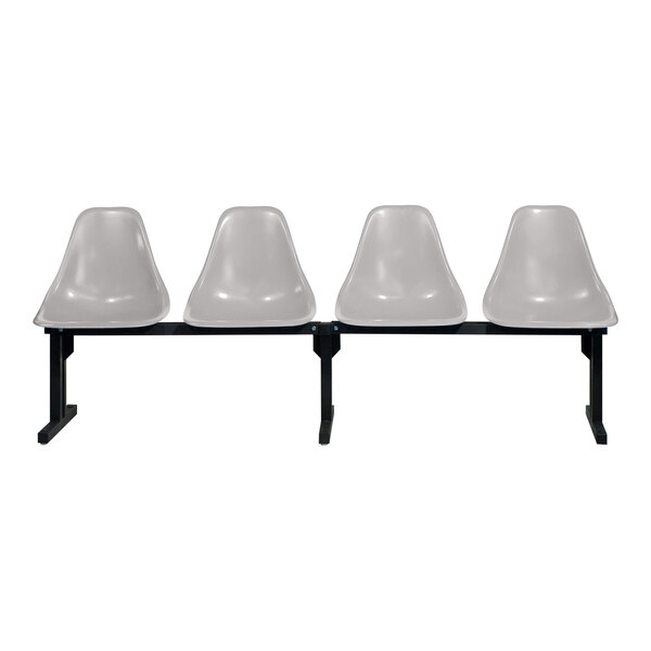 A row of four Sol-O-Matic white plastic chairs with black bases.