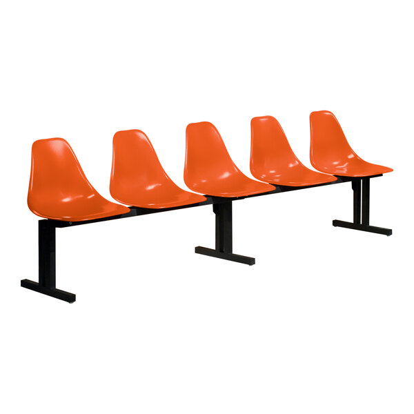 A row of four Sol-O-Matic orange plastic chairs with black legs.