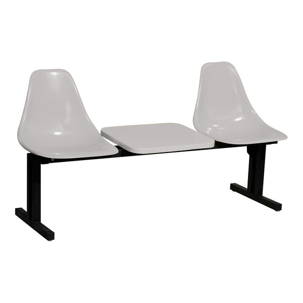 A white Sol-O-Matic modular seating unit with a black table and chair legs.