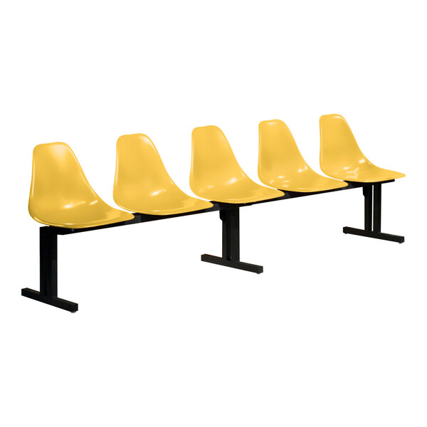 A row of four yellow Sol-O-Matic plastic chairs with black legs.
