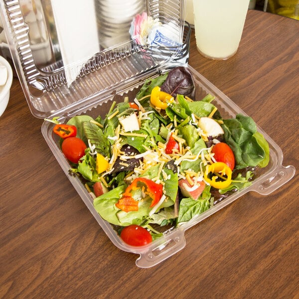 A salad in a Durable Packaging clear hinged lid plastic container.