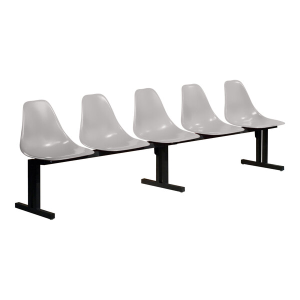 A row of four Sol-O-Matic white plastic chairs with black legs.