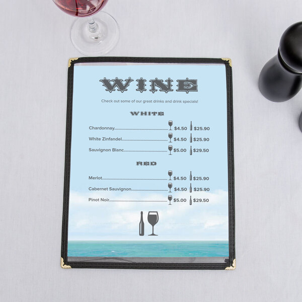 An 8 1/2" x 11" menu with a Mediterranean Parthenon design on a table with a glass of wine.