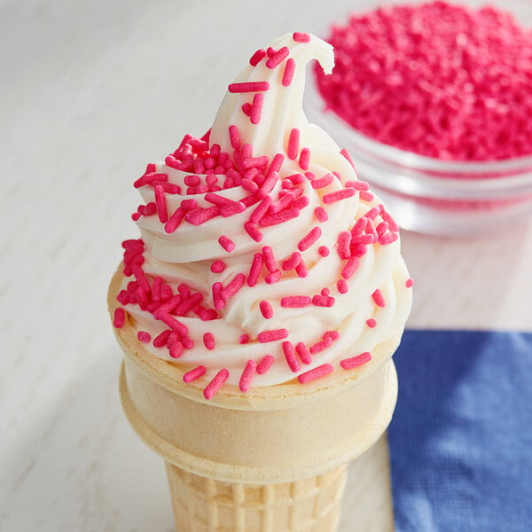 An ice cream cone with pink sprinkles.