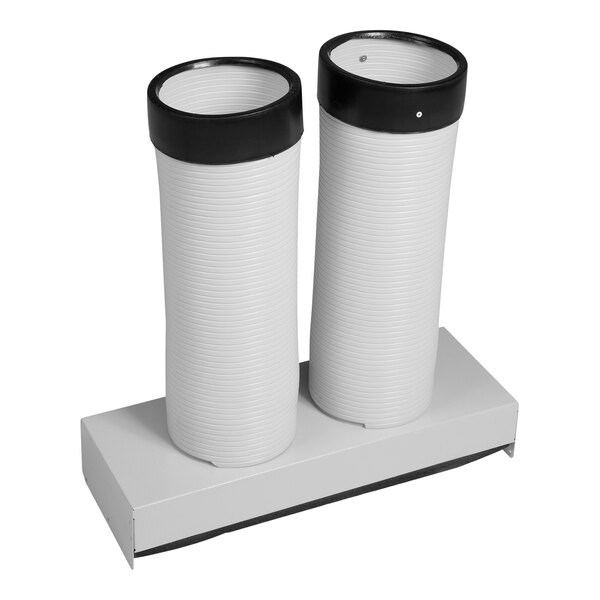A white cup with a pair of white cylindrical lids.