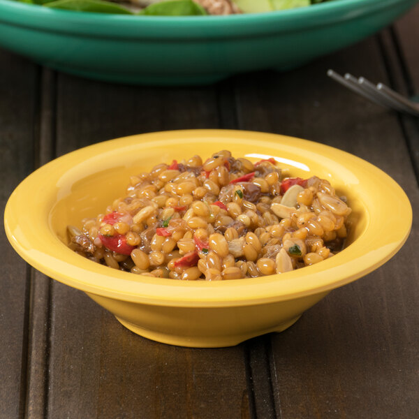 A bowl of rice and salad in a yellow Diamond Mardi Gras melamine bowl.
