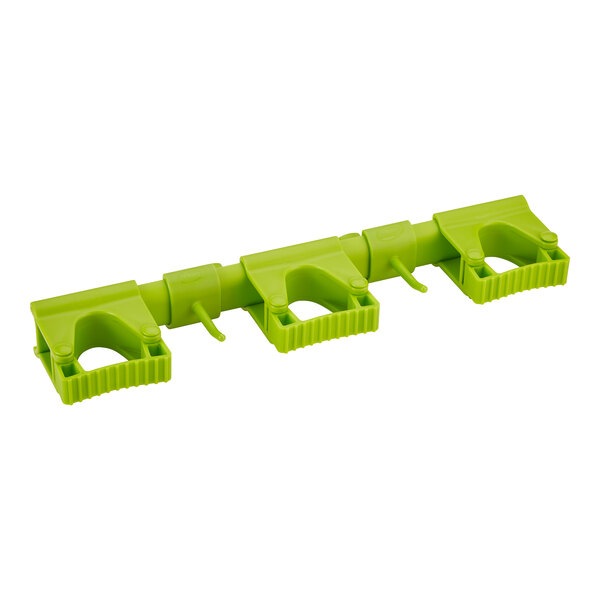 A lime green plastic Vikan wall bracket with three holes.