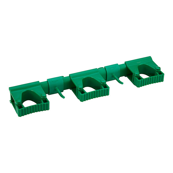 A green plastic pipe with two green plastic hooks.