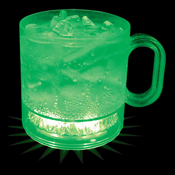 A green plastic mug with ice and bubbles in it sitting on a counter.