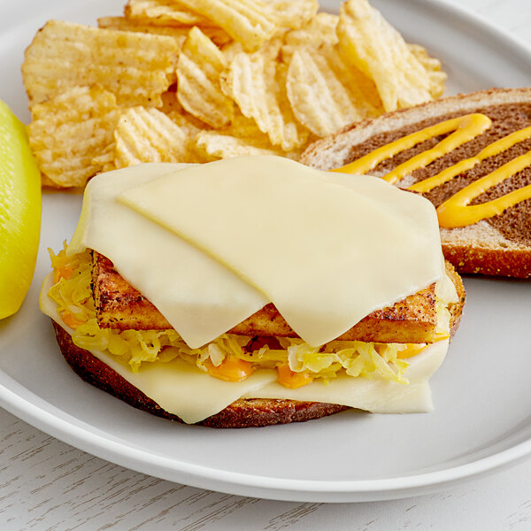 A sandwich with Daiya vegan Swiss cheese on a plate.