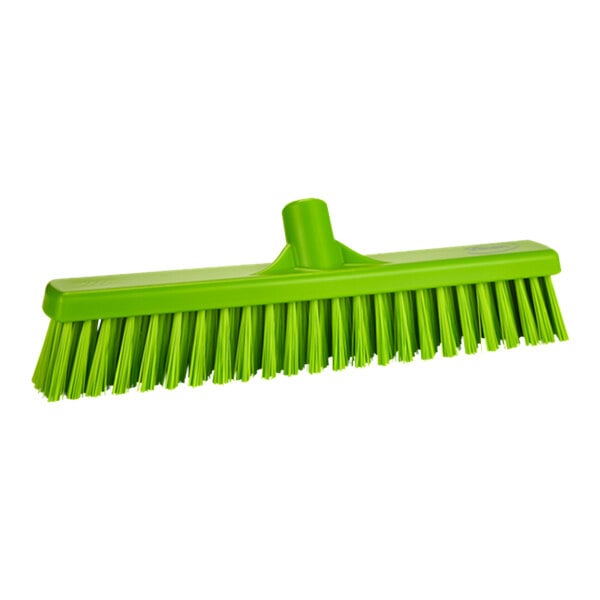 A green broom head with V-shaped bristles on a white background.