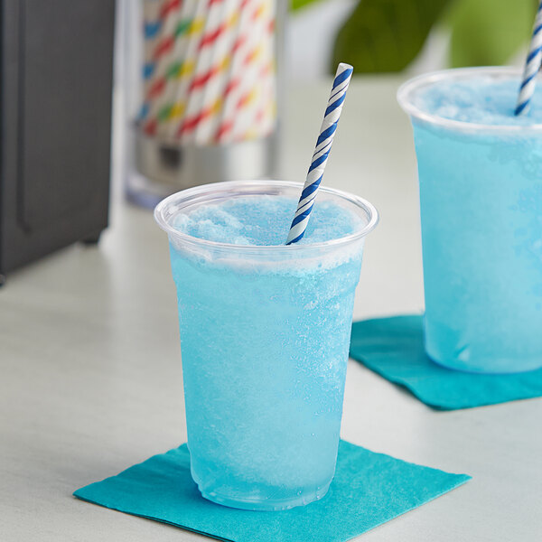 A blue drink in a plastic cup with a straw.