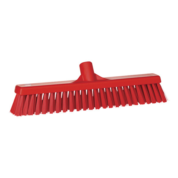 A red broom head with long bristles.