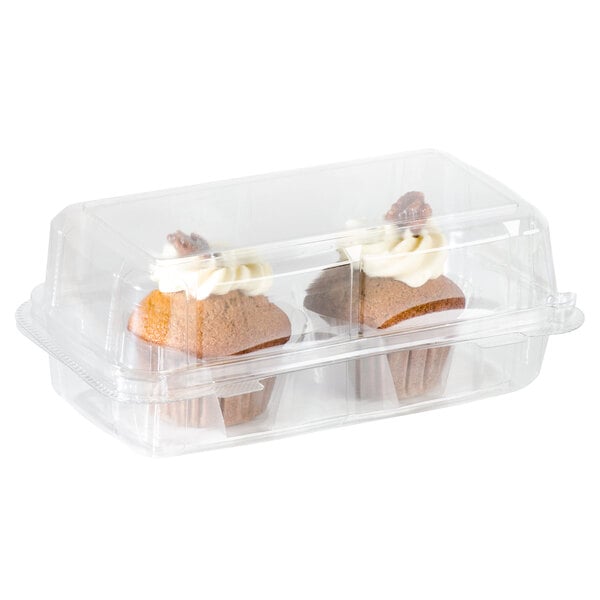 A close-up of two cupcakes in a clear plastic container.