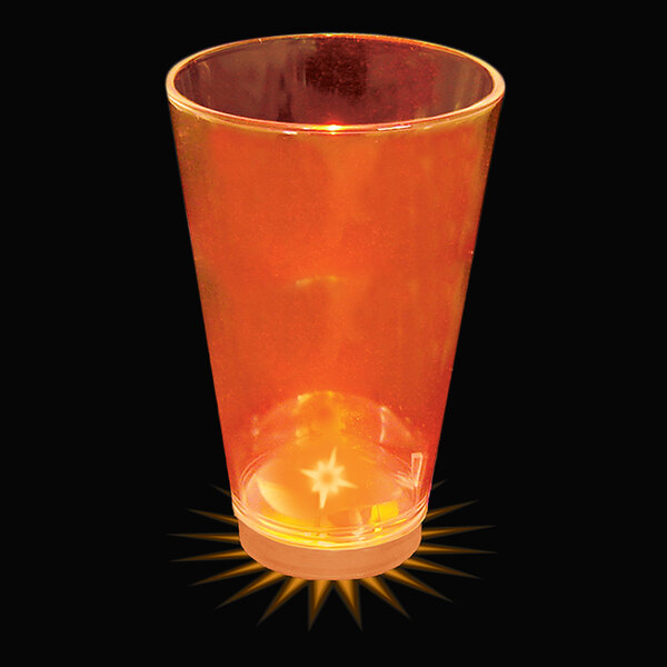 A customizable plastic shot cup with an orange LED light inside of it.
