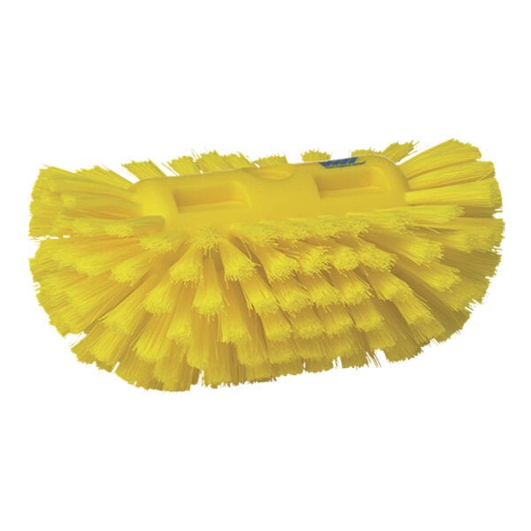 A close-up of a yellow Vikan tank brush head with medium stiff bristles.
