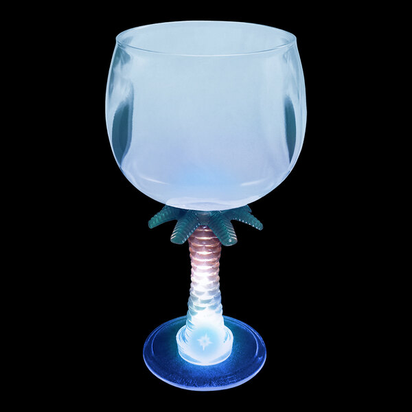 A close-up of a 12 oz. plastic palm tree stem goblet with a blue LED light on it.