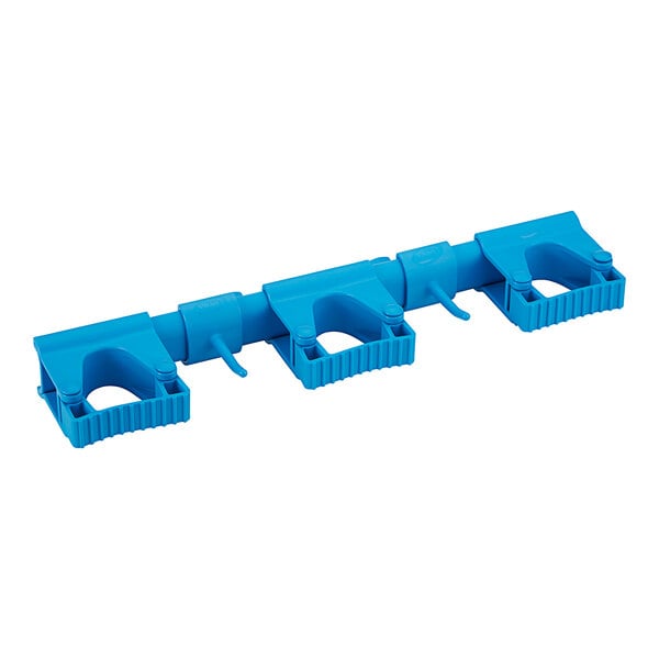 A blue plastic Vikan wall bracket with hooks for three pieces.