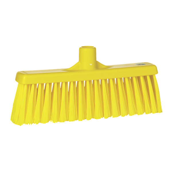 A yellow broom head with unflagged bristles.