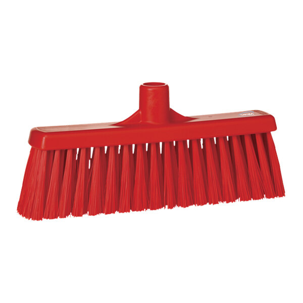 A red broom head with long, unflagged bristles.
