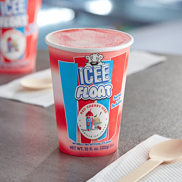 A red and white ICEE Cherry and Vanilla Float cup with a spoon on a table.