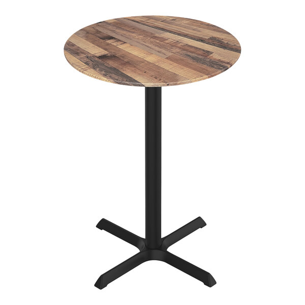 A Holland Bar Stool EuroSlim round rustic wood bar height table with a black metal cross base.