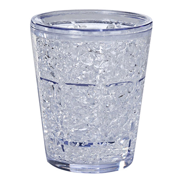A clear Franmara shot glass with ice in it.