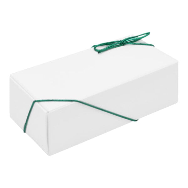 A white box with green ribbon tied to it.