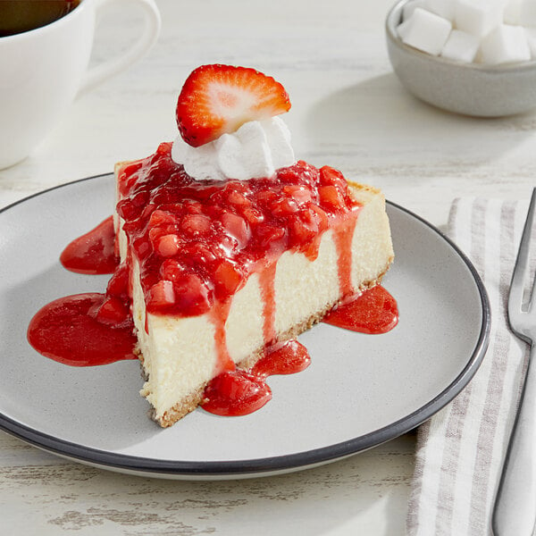 A slice of cheesecake with Oregon Fruit In Hand Original Diced Strawberry on a plate.