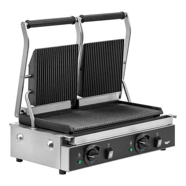 A Vollrath double cast iron panini grill with grooved plates on a counter in a food truck interior.