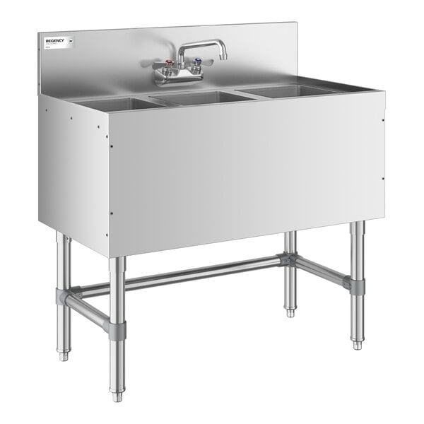 A stainless steel three-compartment sink with a backsplash, faucet, and sturdy metal legs.