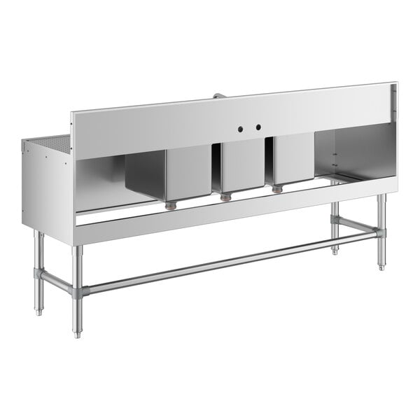 A stainless steel three-bowl underbar sink with two side drainboards and a backsplash, supported by metal legs.