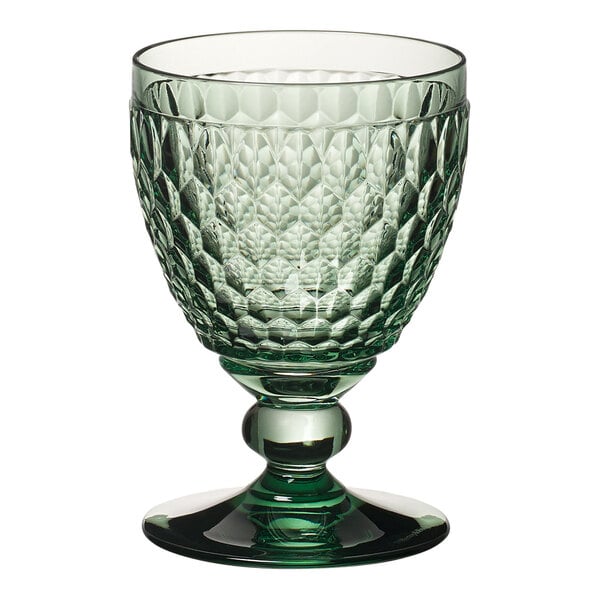 A close-up of a Villeroy & Boch green wine glass with a pattern.