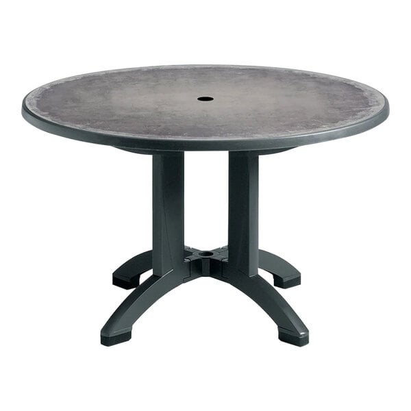 A Grosfillex round table with a zinc top and charcoal legs.