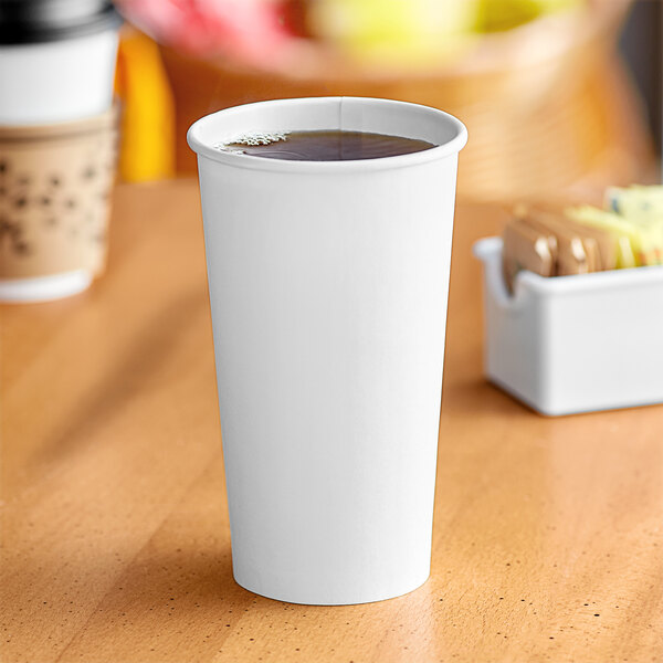 A white Solo paper hot cup of coffee on a table.