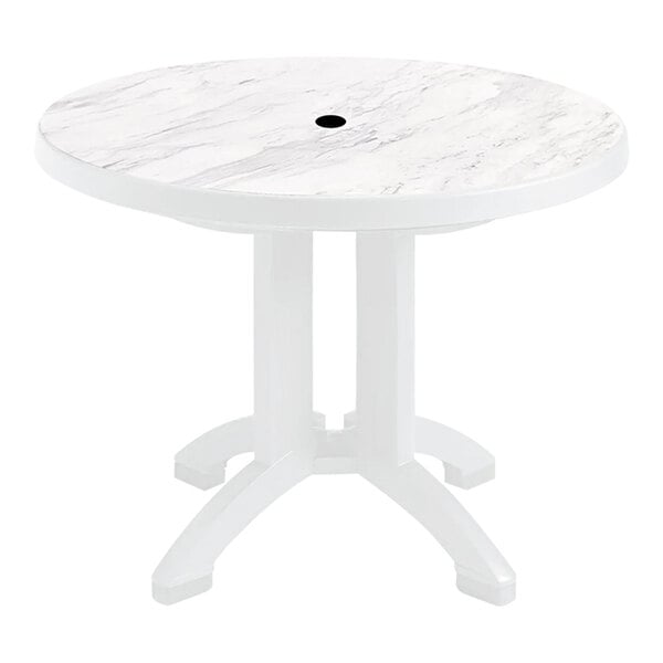 A Grosfillex Aquaba white resin table with white legs and a round top.