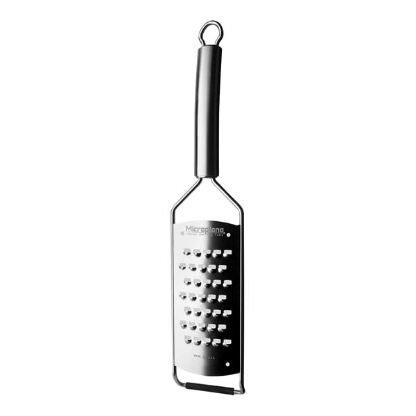 A Microplane stainless steel paddle grater with a metal grate.
