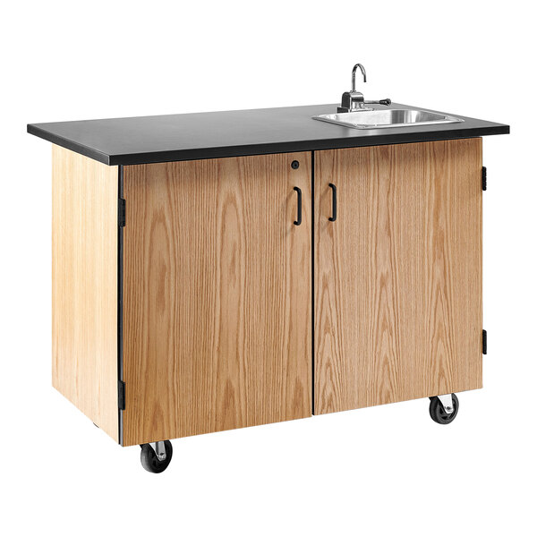 A black mobile science cart with a sink on a black counter.