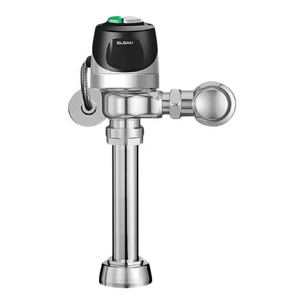 A close-up of a Sloan polished chrome water closet flushometer with a green button.