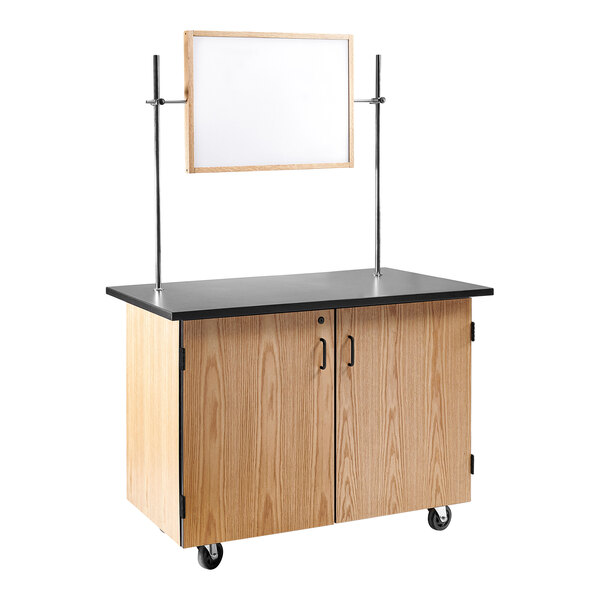 A National Public Seating wooden science cart with a whiteboard and two shelves.
