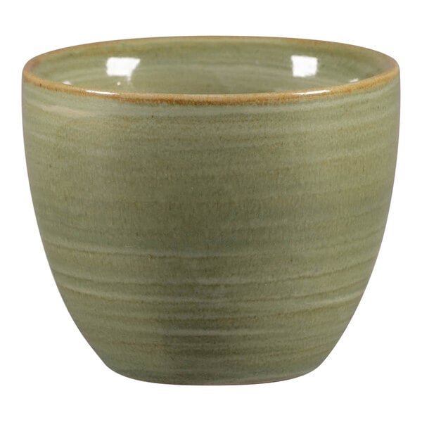 A RAK Porcelain emerald green ceramic cup with a brown rim.