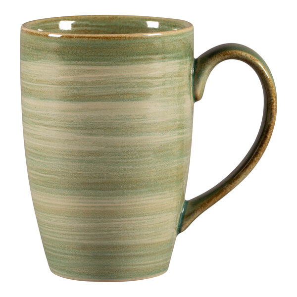A white porcelain mug with a green handle.