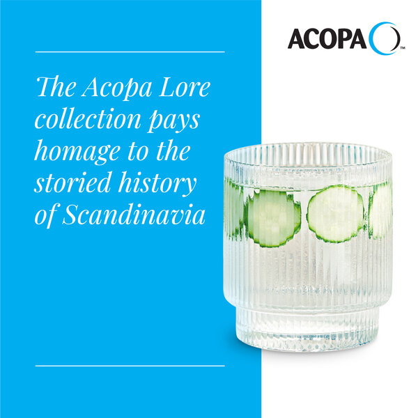 A clear, textured 10 oz. rocks or old fashioned glass from the Acopa Lore collection, shown with a beverage and cucumber slices inside.