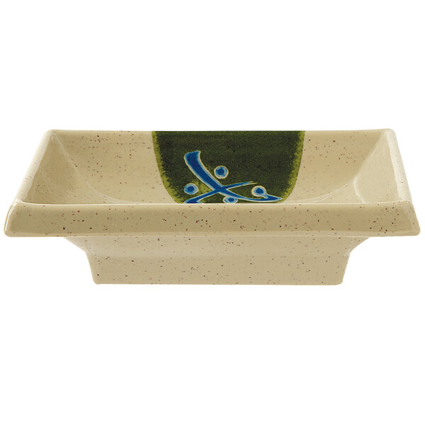 A small square GET sauce dish with a blue and green design.