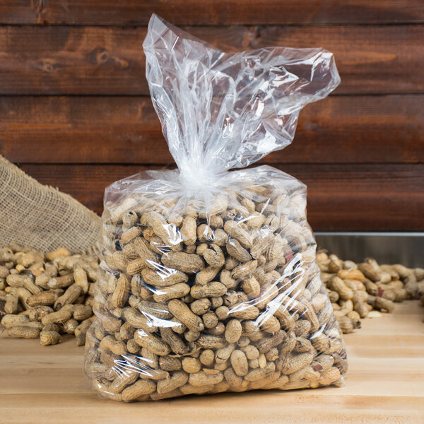 A LK Packaging plastic food bag filled with peanuts on a table.