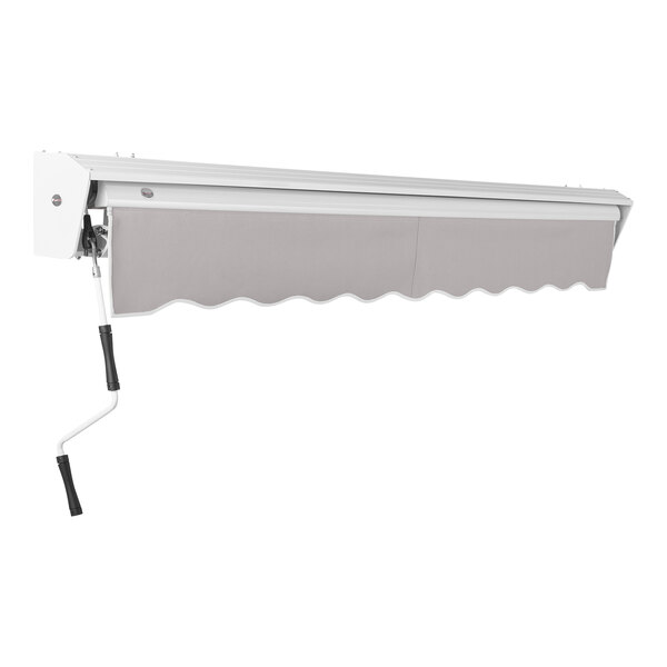 A gray Awntech manual retractable patio awning with protective hood and a metal rod.